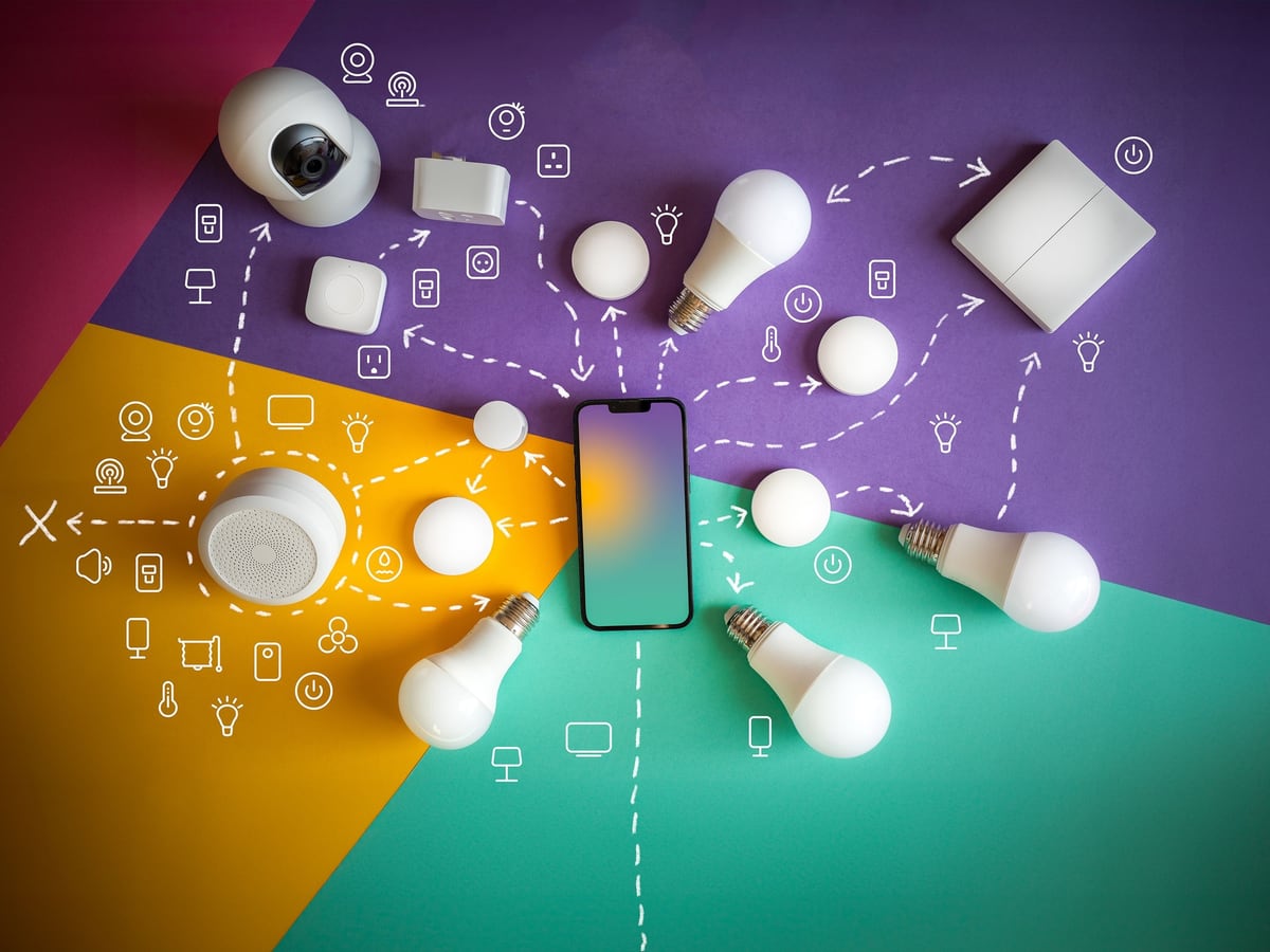 Vom Elektriker eingerichtete Smart-Home-Geräte wie Kamera, Sensoren und Lampen mit der zugehörigen Steuerungs-App